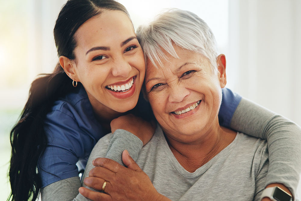 happy woman and nurse hugging