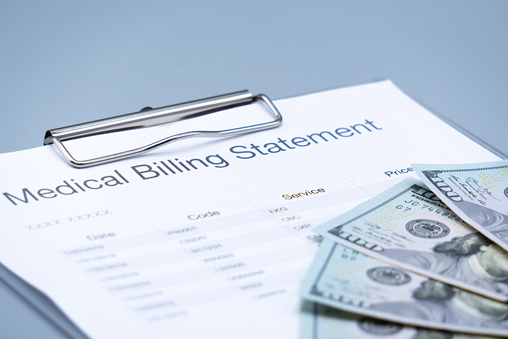 top view picture of medical billing statement, banknotes on the gray background