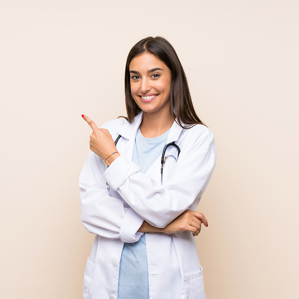 Young doctor woman over isolated background pointing finger to the side