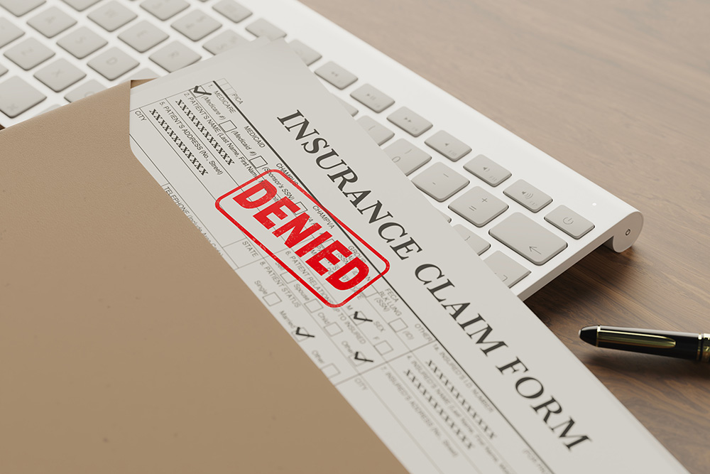 Document with denied stamp put on the wooden table