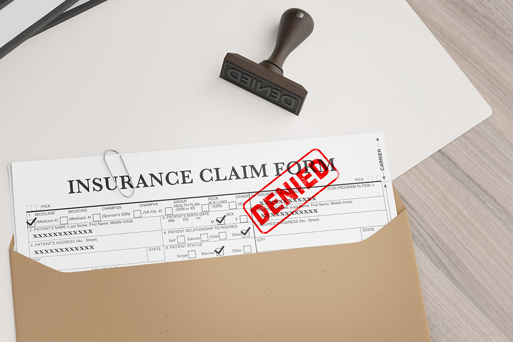 Document with denied stamp and a stamper put on the wooden table