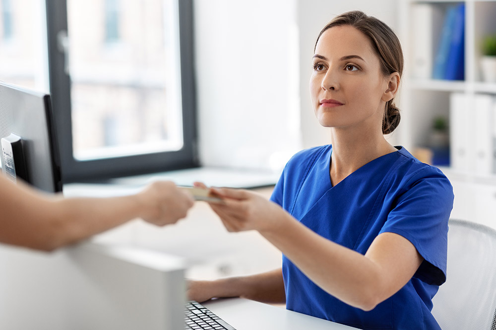 doctor and patient with credit card at hospital