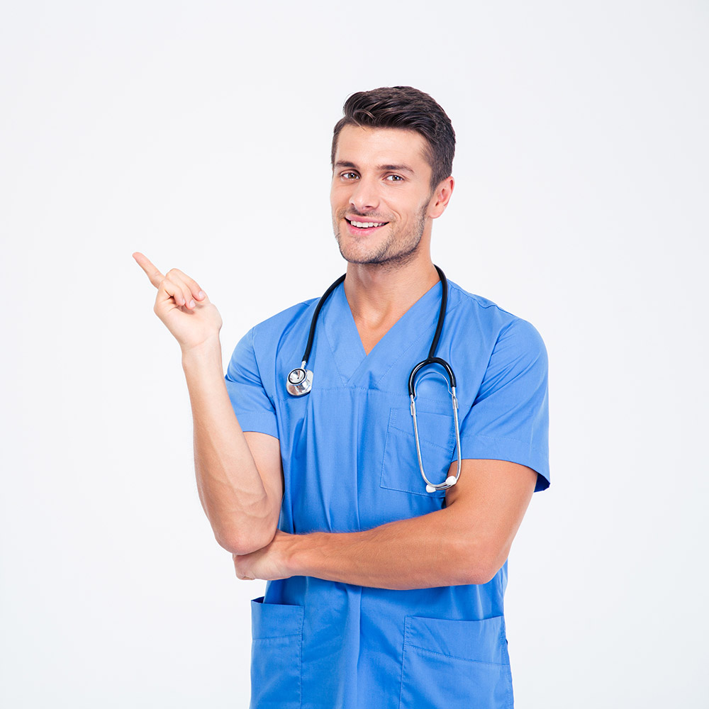 Portrait of a smiling male doctor pointing finger away isolated on a white background