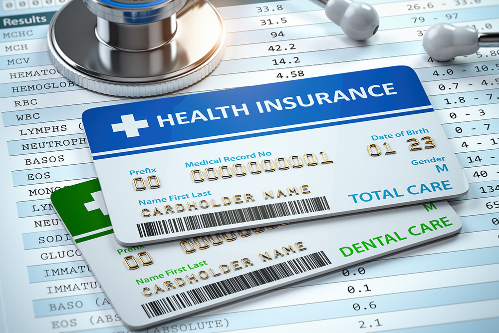 Health Insurance cards total and dental care with stethscope.