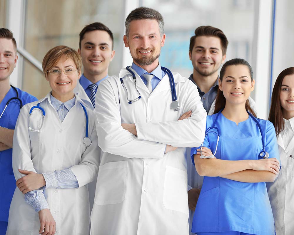 A group of doctors and nurses standing in the hospital