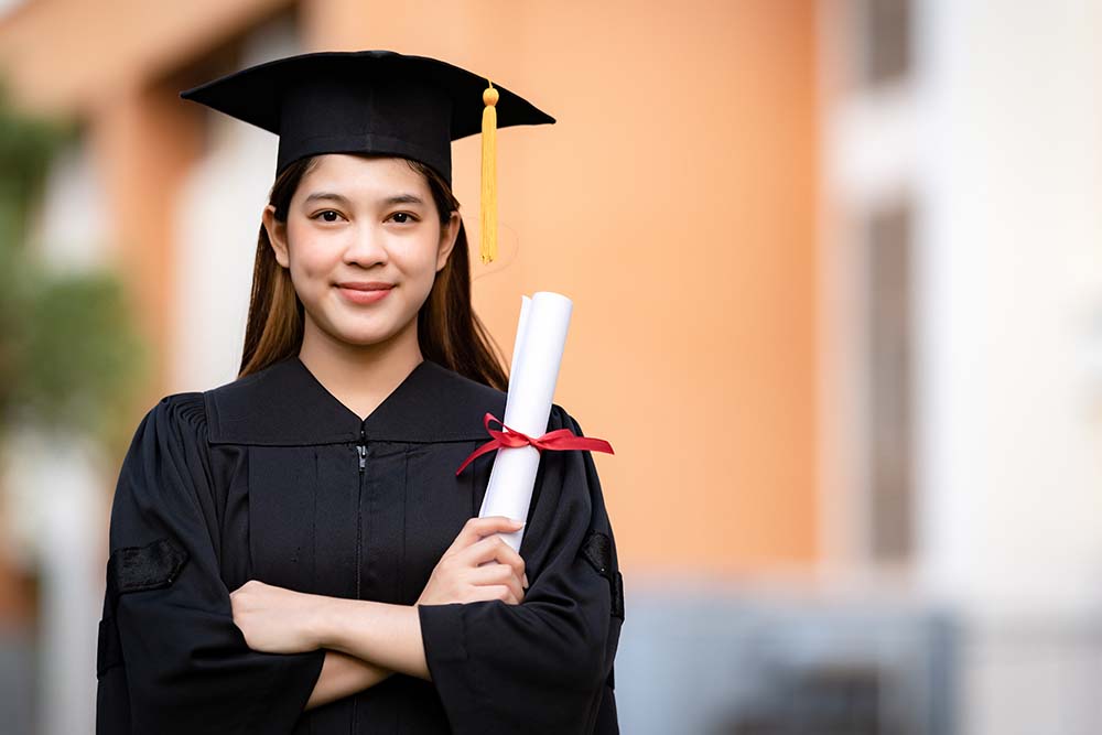 medical school graduate holding her diploma